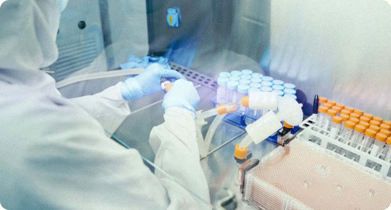 A scientist working with vials in a regenerative medicine laboratory
