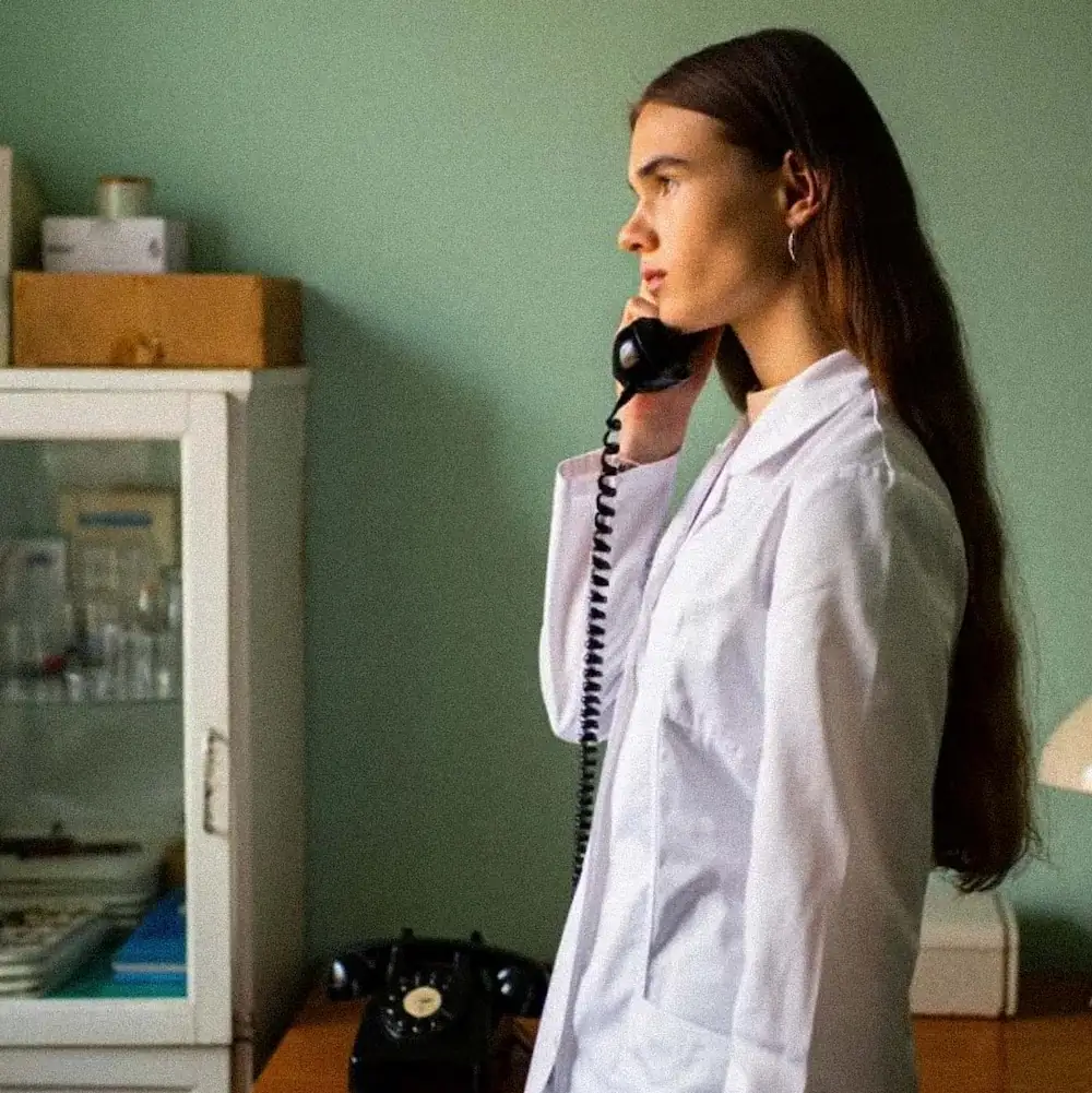 A SOMA patient coordinator speaking with a client by phone