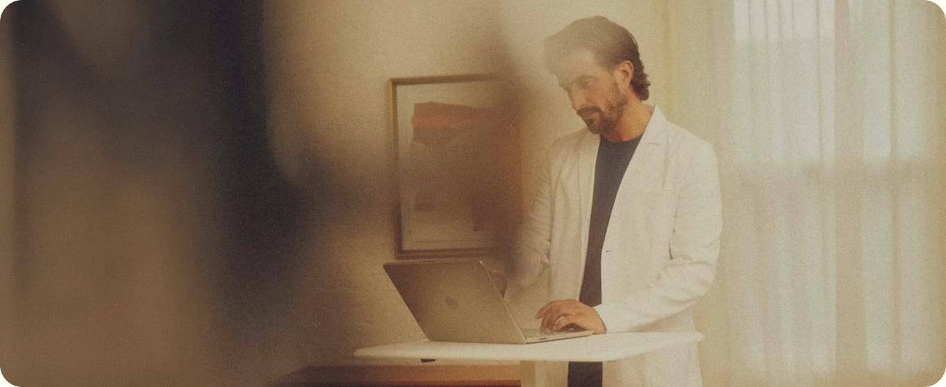 A SOMA client advocate reviewing notes at a laptop