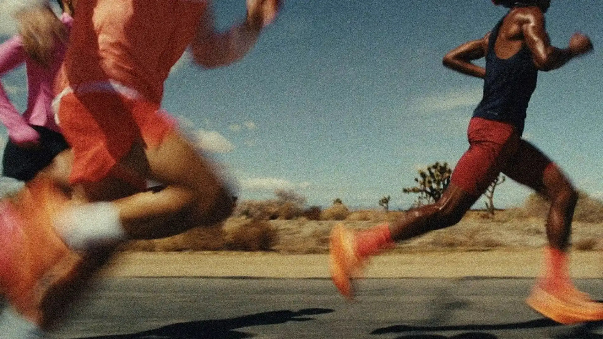 A runner sprinting along a desert road